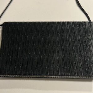 Women’s dressy purse with shoulder strap.